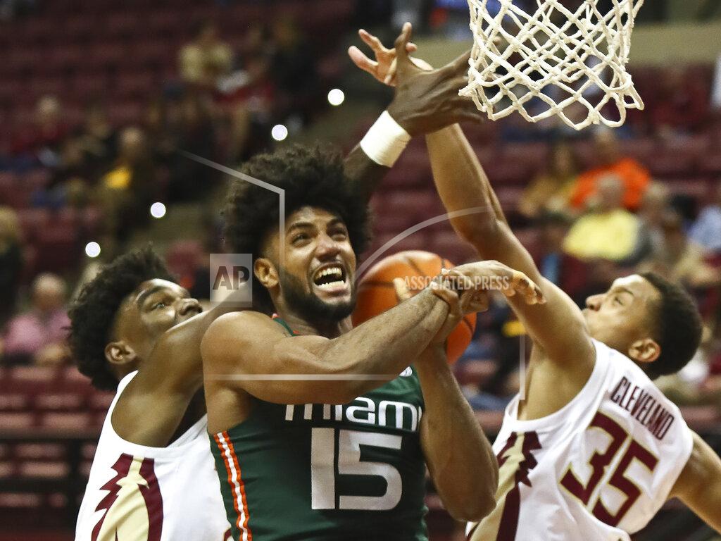 Phil Sears Miami forward Norchad Omier (15) is tied up on a layup attempt by Florida State center Naheem McLeod, left, and Florida State guard Matthew Cleveland (35) in the second half of an NCAA college basketball game in Tallahassee, Fla., Tuesday, Jan. 24, 2023. (AP Photo/Phil Sears)