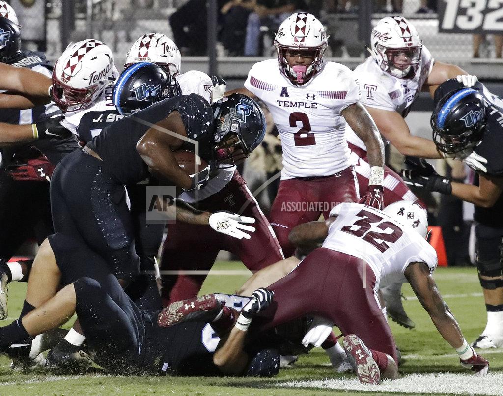 John Raoux Central Florida running back Taj McGowan, front left, runs past the Temple defense for a 1-yard touchdown during the first half of an NCAA college football game Thursday, Nov. 1, 2018, in Orlando, Fla. (AP Photo/John Raoux)