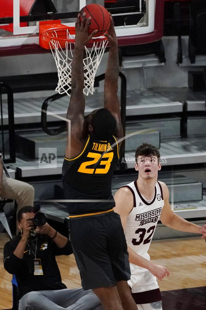 Rogelio V. Solis Mississippi State forward Quinten Post (32) watches as Missouri forward Jeremiah Tilmon (23) dunks during the first half of an NCAA college basketball game Tuesday, Jan. 5, 2021, in Starkville, Miss. (AP Photo/Rogelio V. Solis)