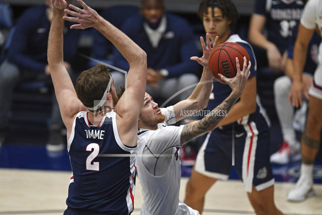 Jose Carlos Fajardo Saint Mary's Logan Johnson (0) drives past Gonzaga Drew Timme (2) during the first half of an NCAA college basketball game in Moraga, Calif., Saturday, Jan. 16, 2021. (Jose Carlos Fajardo/Bay Area News Group via AP)
