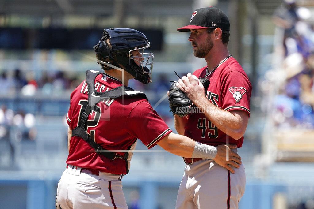 Marcio Jose Sanchez Arizona Diamondbacks starter Tyler Gilbert, right, gets a visit to the mound by catcher Daulton Varsho (12) after Gilbert gave up a solo home run to Los Angeles Dodgers' Trea Turner during the sixth inning of the first game of a baseball double-header Tuesday, May 17, 2022, in Los Angeles. (AP Photo/Marcio Jose Sanchez)