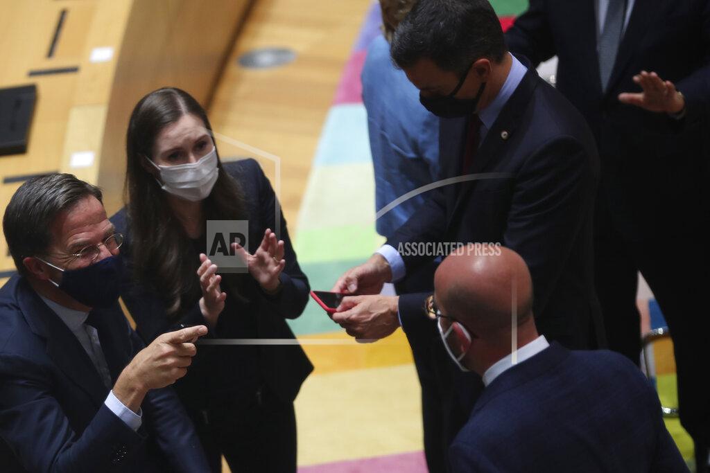Francisco Seco From left, Dutch Prime Minister Mark Rutte, Finland's Prime Minister Sanna Marin and European Council President Charles Michel speaks during a round table meeting at an EU summit in Brussels, Monday, July 20, 2020. Weary European Union leaders are expressing cautious optimism that a deal is in sight on their fourth day of wrangling over an unprecedented budget and coronavirus recovery fund. (AP Photo/Francisco Seco, Pool)