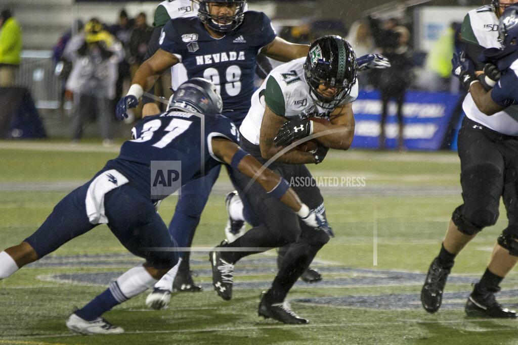 Tom R. Smedes Hawaii running back Fred Holly III (21) is hit by Nevada's Daylon Johnson (37) in the first half of an NCAA college football game in Reno, Nev. Saturday, Sept. 28, 2019. (AP Photo/Tom R. Smedes)