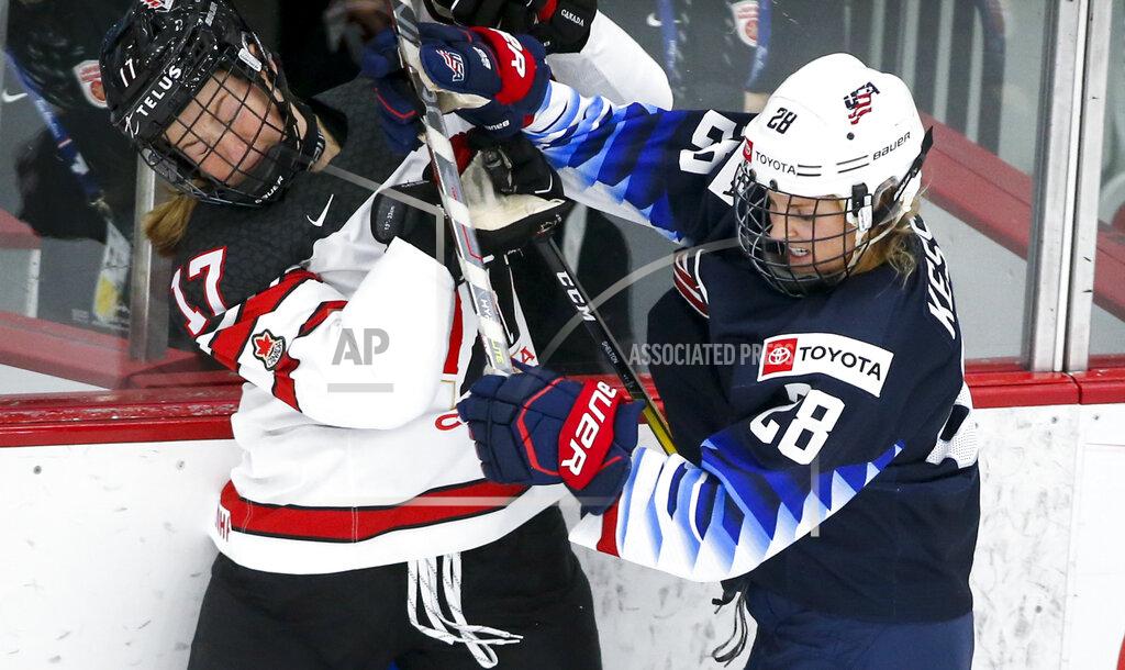 Jeff Mcintosh Canada's Ella Shelton, left, is checked by United States' Amanda Kessel during the third period of an IIHF women’s world hockey championships game Thursday, Aug. 26, 2021, in Calgary, Alberta. (Jeff McIntosh/The Canadian Press via AP)