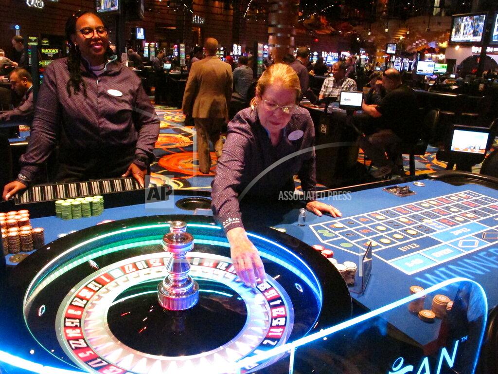 Wayne Parry FILE - Dealers carry out a game of roulette at the Ocean Casino Resort in Atlantic City N.J., in this June 18, 2019, file photo. On April 6, 2021, Luxor Capital, the New York hedge fund that owns the casino, told The Associated Press it is selling an ownership interest of up to 50% in the casino to the Ilitch family of Detroit, which owns professional sports teams, the Little Caesars pizza chain, and a Detroit casino. (AP Photo/Wayne Parry, File)