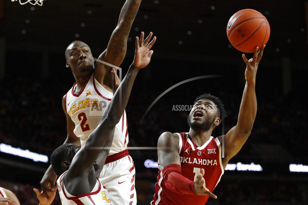 Charlie Neibergall Oklahoma guard Rashard Odomes, right, shoots over Iowa State's Marial Shayok and Cameron Lard (2) during the first half of an NCAA college basketball game, Monday, Feb. 25, 2019, in Ames, Iowa. (AP Photo/Charlie Neibergall)