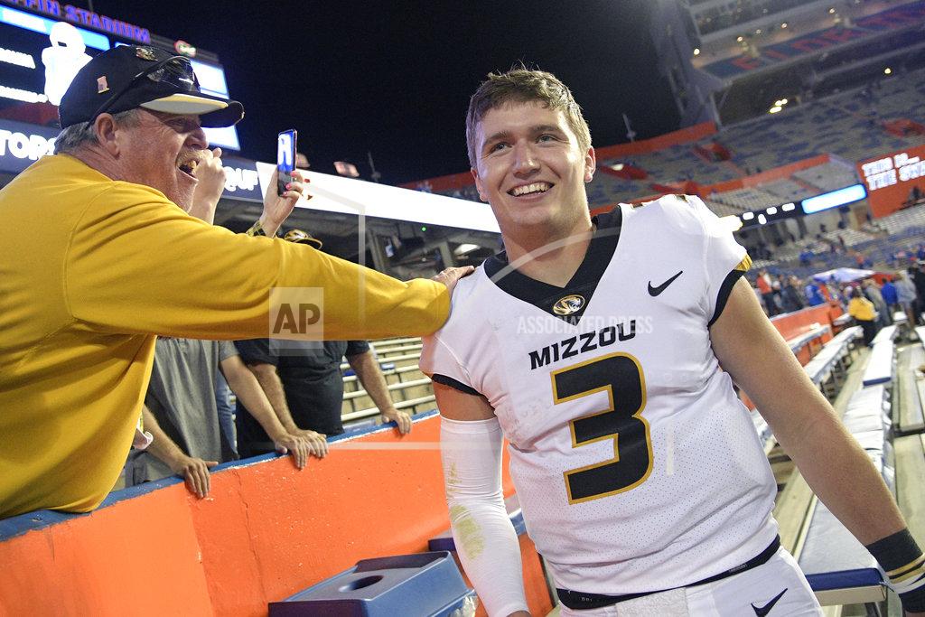 Phelan M. Ebenhack Missouri quarterback Drew Lock (3) is congratulated by fans in the stands after an NCAA college football game against Florida, Saturday, Nov. 3, 2018, in Gainesville, Fla. (AP Photo/Phelan M. Ebenhack)