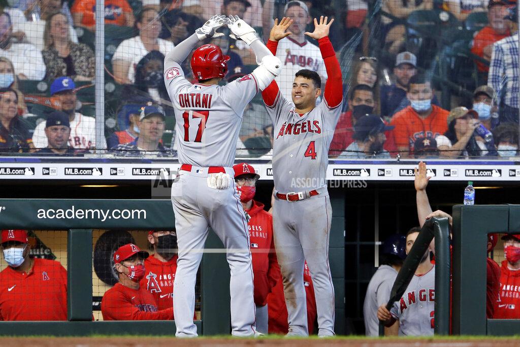 Michael Wyke Los Angeles Angels designated hitter Shohei Ohtani (17) and Jose Iglesias (4) high five at the dugout after Ohtani's home run during the eighth inning of a baseball game against the Houston Astros Sunday, April 25, 2021, in Houston. (AP Photo/Michael Wyke)