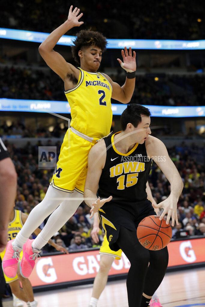 Nam Y. Huh Michigan's Jordan Poole (2) collides with Iowa's Ryan Kriener (15) during the first half of an NCAA college basketball game in the quarterfinals of the Big Ten Conference tournament, Friday, March 15, 2019, in Chicago. (AP Photo/Nam Y. Huh)