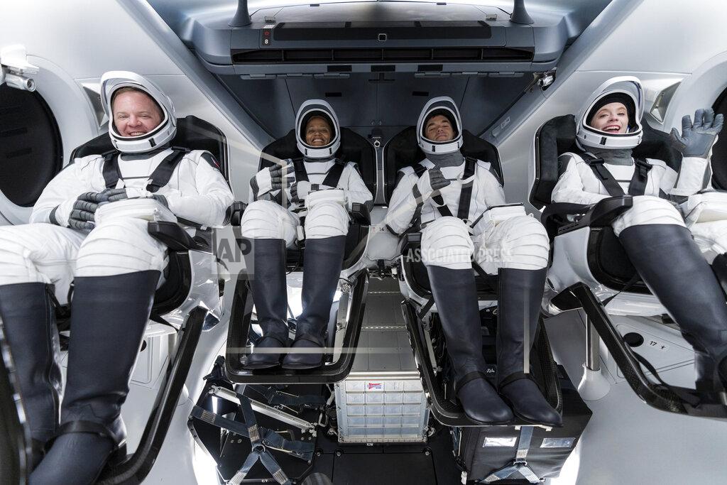 Uncredited In this Sunday, Sept. 12, 2021 photo made available by SpaceX, from left, Chris Sembroski, Sian Proctor, Jared Isaacman and Hayley Arceneaux sit in the Dragon capsule at Cape Canaveral in Florida, during a dress rehearsal for the upcoming launch. The fully automated Dragon is the same kind that SpaceX uses to send astronauts to and from the International Space Station for NASA. But the chartered flight won't be going there. (SpaceX via AP)