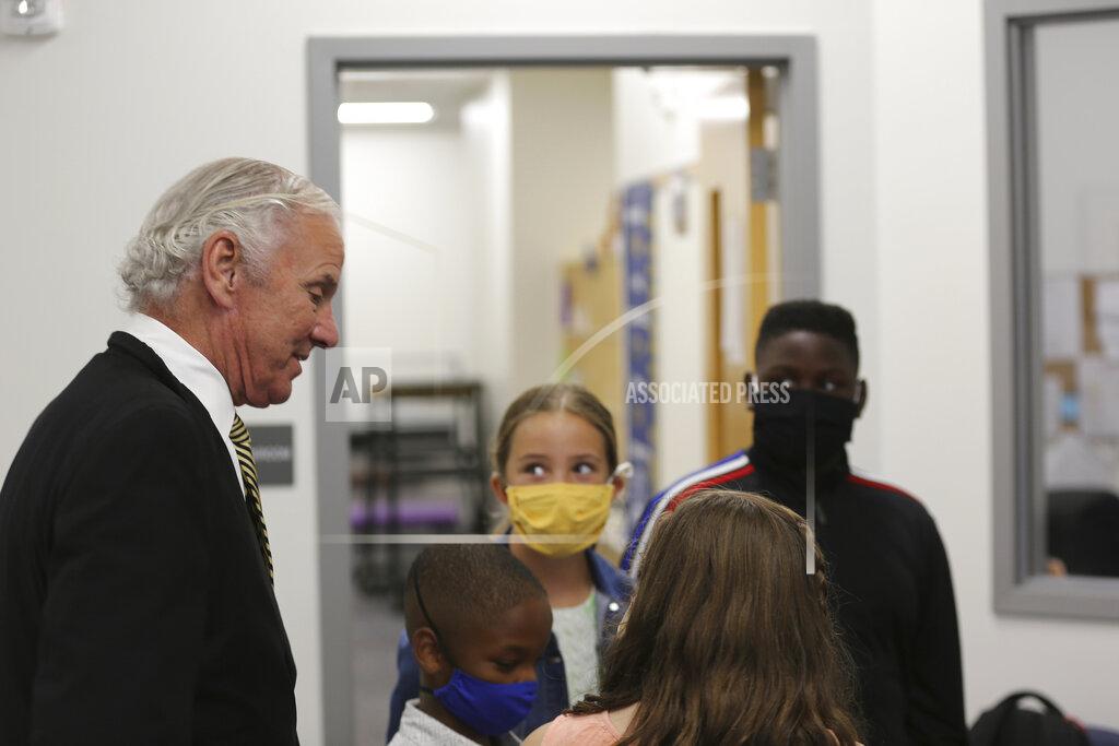 Jeffrey Collins Camden Elementary School students in masks listen as South Carolina Gov. Henry McMaster talks to them on Wednesday, Sept. 15, 2021, in Camden, S.C. McMaster has adamantly and repeatedly come out against requiring face masks in schools even as the average number of daily COVID-19 cases in the state has risen since early June. AP Photo/Jeffrey Collins)