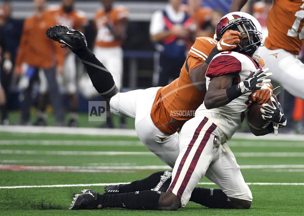 Jeffrey Mcwhorter Texas defensive back Kris Boyd grabs the facemask of Oklahoma wide receiver Marquise Brown during the first half of the Big 12 Conference championship NCAA college football game on Saturday, Dec. 1, 2018, in Arlington, Texas. (AP Photo/Jeffrey McWhorter)
