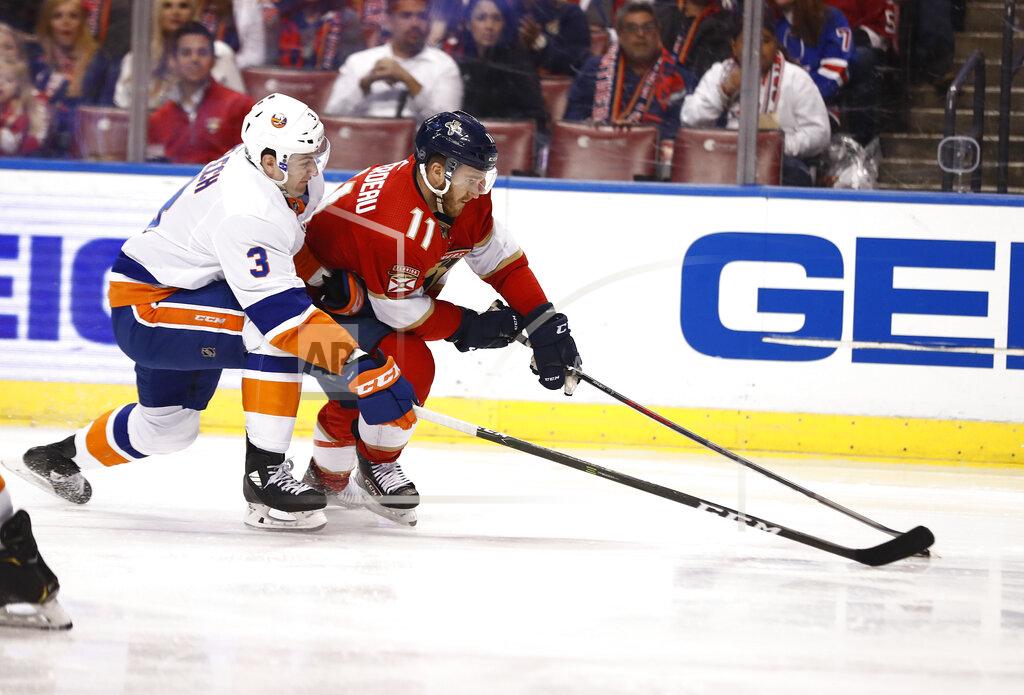 Brynn Anderson New York Islanders defenseman Adam Pelech (3) and Florida Panthers left wing Jonathan Huberdeau (11) fight for the puck during the second period of an NHL hockey game on Thursday, April 4, 2019, in Sunrise, Fla. (AP Photo/Brynn Anderson)
