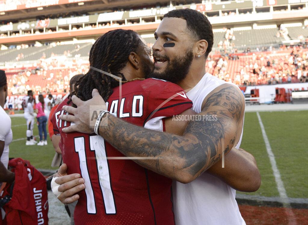 Jason Behnken Arizona Cardinals wide receiver Larry Fitzgerald (11) hugs Tampa Bay Buccaneers wide receiver Mike Evans after an NFL football game Sunday, Nov. 10, 2019, in Tampa, Fla. (AP Photo/Jason Behnken)