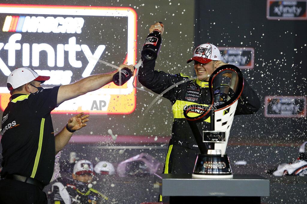 Ralph Freso Austin Cindric, right, is sprayed by a crew member as he celebrates in Victory Lane after winning the season championship and aNASCAR Xfinity Series auto race at Phoenix Raceway, Saturday, Nov. 7, 2020, in Avondale, Ariz. (AP Photo/Ralph Freso)
