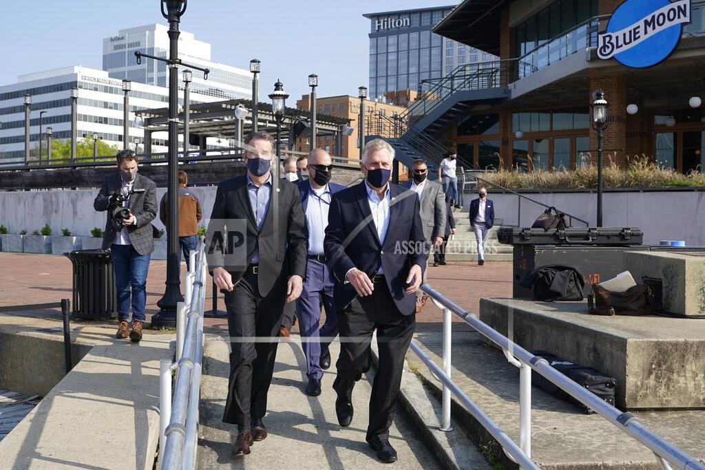 Steve Helber Virginia Gov. Ralph Northam, left, arrives with former Gov. and Democratic gubernatorial candidate, Terry McAuliffe, right, for a news conference at Waterside in Norfolk, Va., Thursday, April 8, 2021. Northam endorsed McAuliffe for governor. (AP Photo/Steve Helber)