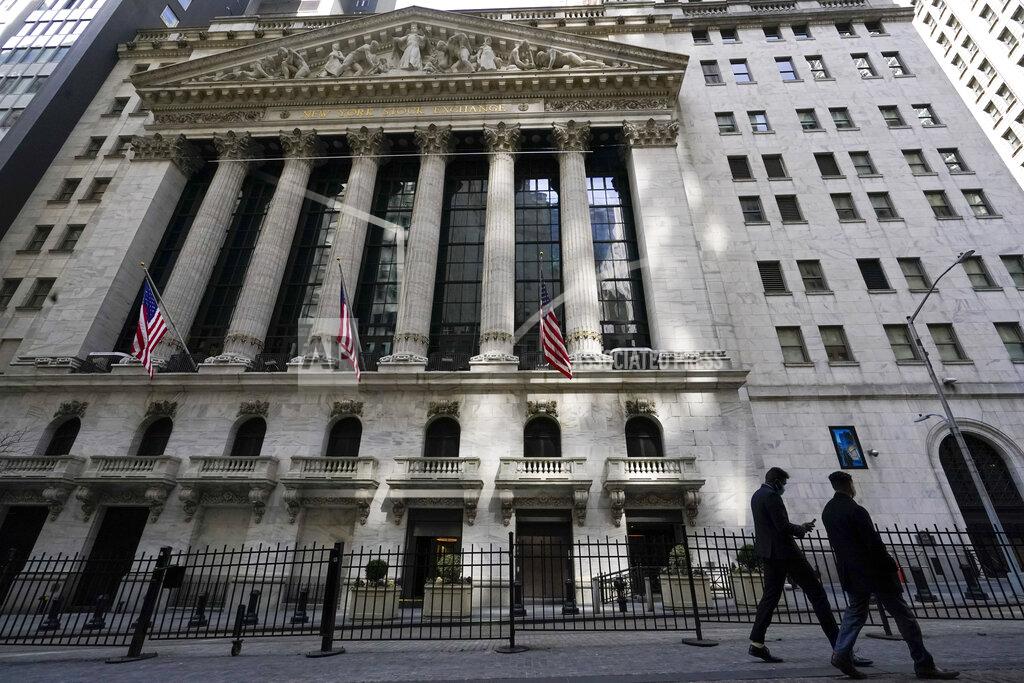FILE - In this March 23, 2021 file photo, pedestrians walk past the New York Stock Exchange in New York's Financial District. Stocks are pulling back in the early going on Wall Street, easing the S&P 500 below the record high it set a day earlier. The index is still on track to close out its third solid monthly gain in a row. It was down 0.5% in the first few minutes of trading Friday, April 30, and technology and communications stocks were doing the most damage. (AP Photo/Mary Altaffer, File)