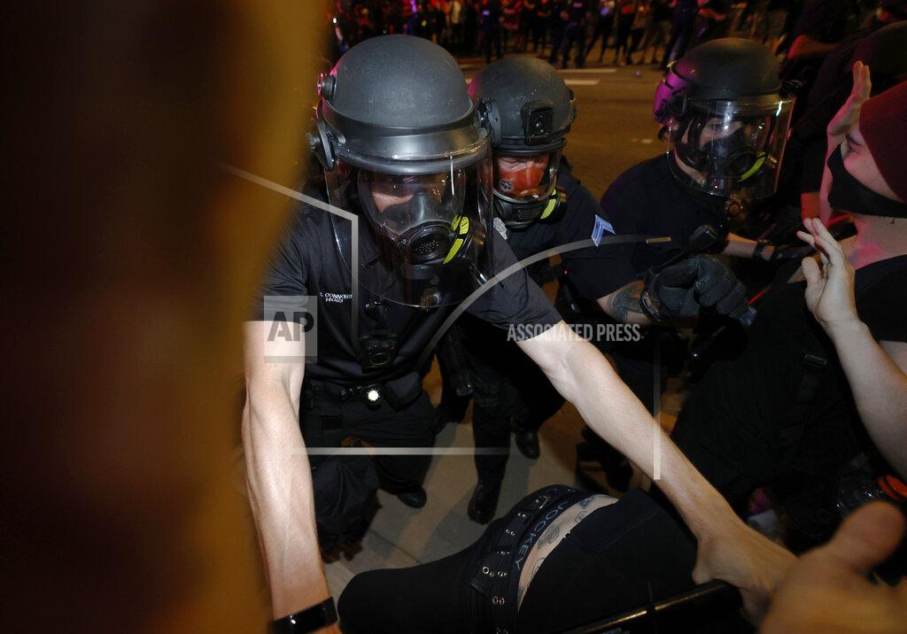 David Zalubowski Denver police officers uses batons to push back protesters outside the State Capitol on Thursday, May 28, 2020, in Denver, during a demonstration over the Monday death of George Floyd in Minneapolis police custody. (AP Photo/David Zalubowski)