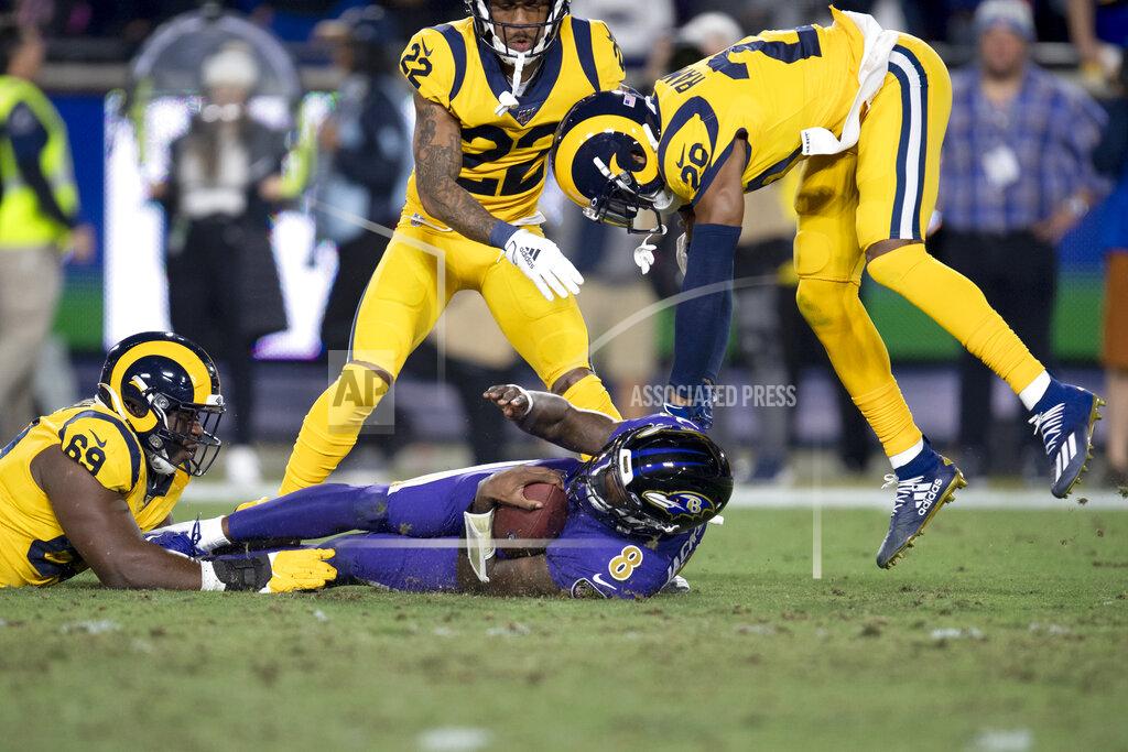 Kyusung Gong Baltimore Ravens quarterback Lamar Jackson, middle, is tackled by Los Angeles Rams defensive tackle Sebastian Joseph-Day, left, and cornerback Jalen Ramsey during the first half of an NFL football game Monday, Nov. 25, 2019, in Los Angeles. (AP Photo/Kyusung Gong)