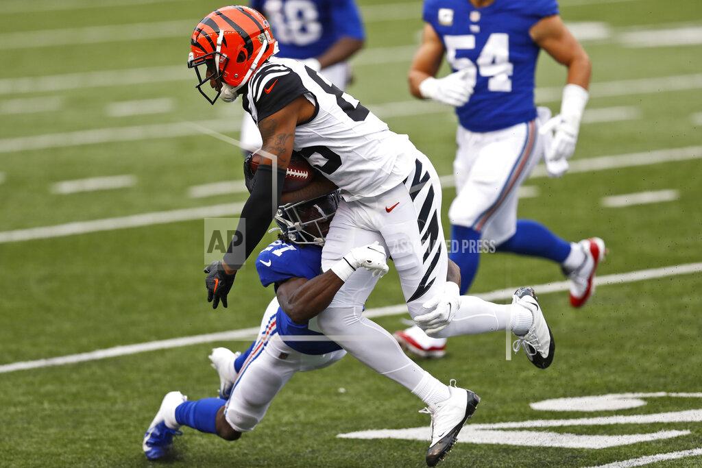 Aaron Doster New York Giants cornerback Isaac Yiadom (27) tackles Cincinnati Bengals wide receiver Tee Higgins (85) during the second half of NFL football game, Sunday, Nov. 29, 2020, in Cincinnati. (AP Photo/Aaron Doster)
