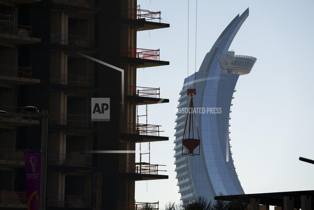 Pavel Golovkin A crane operates on a construction site with the Crescent Tower Lusail in the background in Lusail downtown, Qatar, Thursday, Nov. 24, 2022. (AP Photo/Pavel Golovkin)