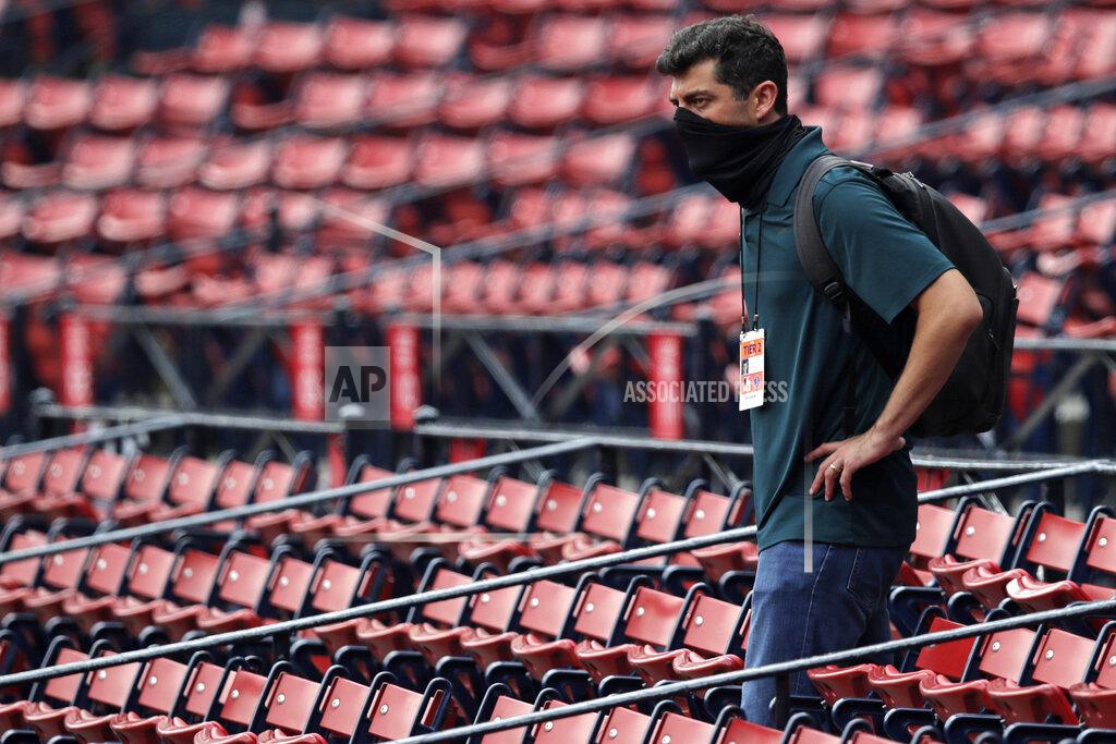 Charles Krupa Boston Red Sox chief baseball officer Chaim Bloom wears a protective mask while watching practice at Fenway Park on Thursday, July 9, 2020, in Boston. (AP Photo/Charles Krupa)