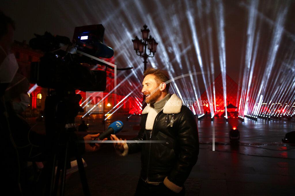 Thibault Camus French DJ David Guetta answers reporters in the courtyard of the Louvre museum, in Paris, Tuesday, Dec. 29, 2020 before recording his show. Superstar DJ David Guetta has, quite literally, been brought back to Earth by the coronavirus pandemic and says his music has benefitted as a result. Back in his native Paris to record a New Year's Eve show, the composer of ear-worm dance hits said he has produced "tons of new music" while hunkering down from the virus.(AP Photo/Thibault Camus)