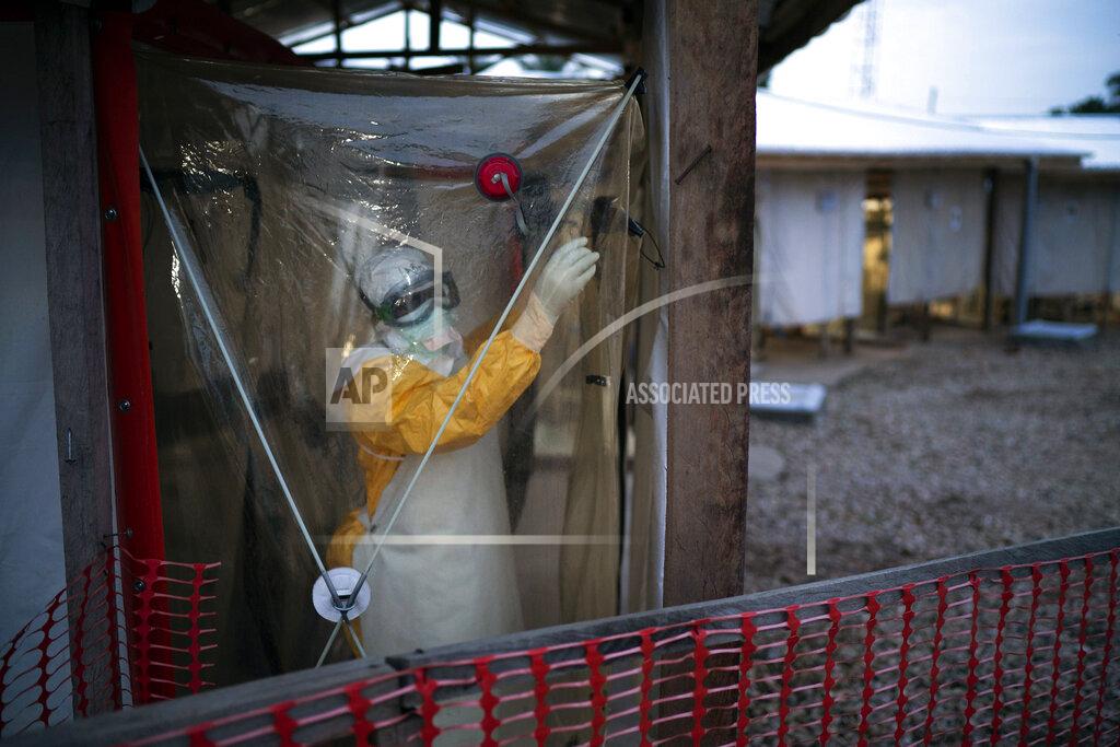 Jerome Delay FILE - In this Saturday, July 13, 2019, file photo, a health worker wearing protective suit enters an isolation pod to treat a patient at a treatment center in Beni, Congo DRC. The World Health Organization and other partners said Tuesday Jan. 12, 2021, they are creating a global emergency stockpile of about 500,000 vaccines of Ebola vaccine to help stamp out any future outbreaks of the disease.(AP Photo/Jerome Delay, File)
