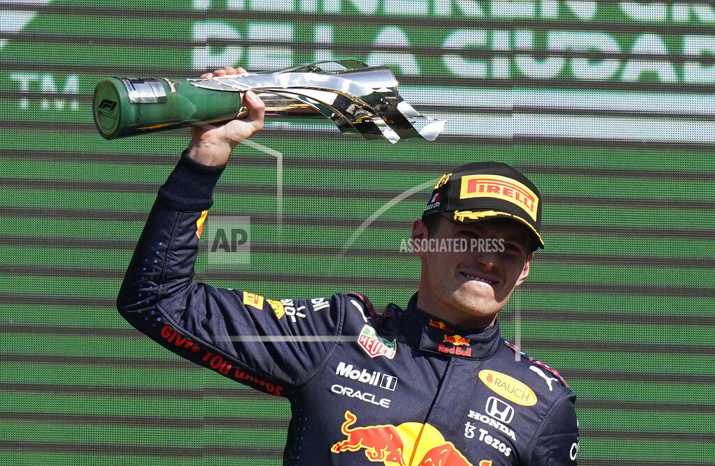 Eduardo Verdugo Red Bull driver Max Verstappen, of The Netherlands, celebrates with the trophy after winning the Formula One Mexico Grand Prix auto race at the Hermanos Rodriguez racetrack in Mexico City, Sunday, Nov. 7, 2021. (AP Photo/Eduardo Verdugo)