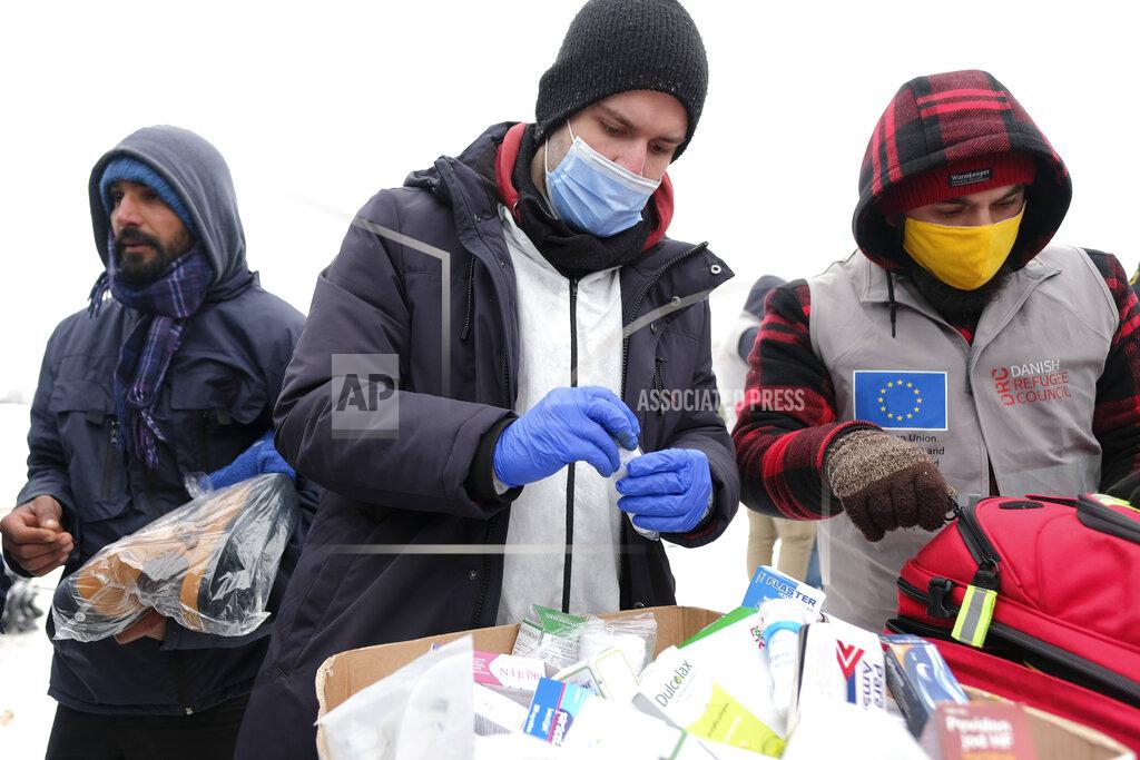 Kemal Softic Medical staff examine migrants at the Lipa camp, outside Bihac, Bosnia, Monday, Jan. 11, 2021. Aid workers say migrants staying at a camp in northwestern Bosnia have complained or respiratory and skin diseases after spending days in make-shift tents and containers amid freezing weather and snow blizzards. Most of the hundreds of migrants at the Lipa facility near Bosnia's border with Croatia on Monday have been accommodated in heated military tents following days of uncertainty after a fire gutted most of the camp on Dec. 23. (AP Photo/Kemal Softic)