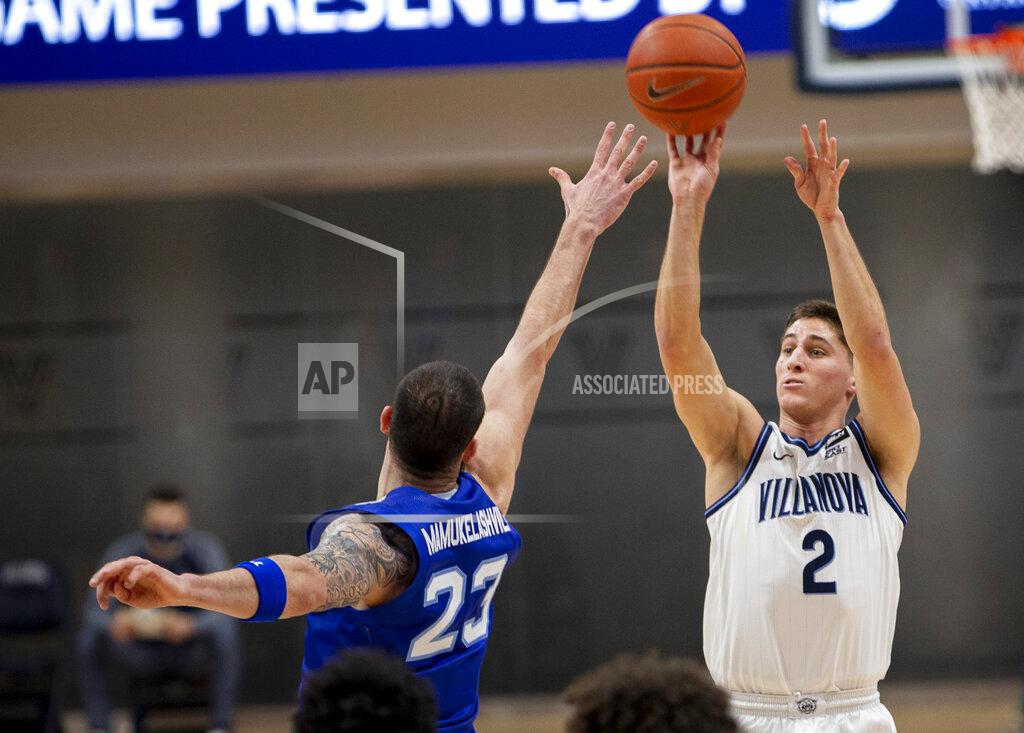 Laurence Kesterson Villanova guard Collin Gillespie (2) takes a shot over Seton Hall forward Sandro Mamukelashvili (23) during the first half of an NCAA college basketball game, Tuesday, Jan. 19, 2021, in Villanova, Pa. (AP Photo/Laurence Kesterson)
