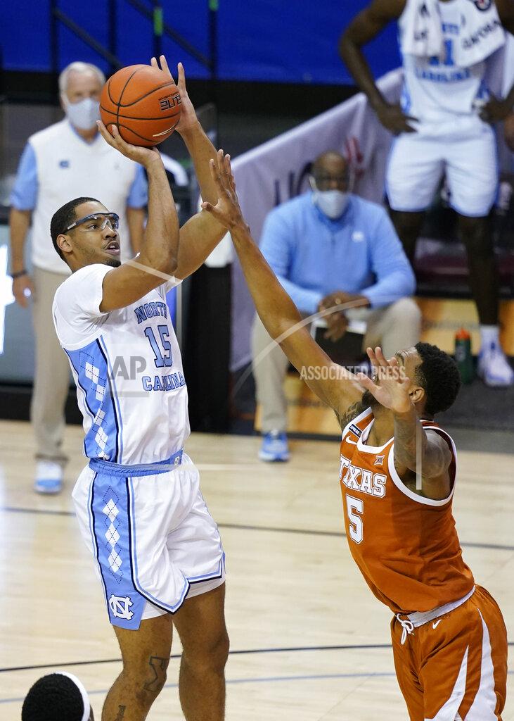 Kathy Kmonicek North Carolina forward Garrison Brooks (15) takes aim for the basket over Texas forward Royce Hamm Jr. (5) in the second half of an NCAA college basketball game for the championship of the Maui Invitational, Wednesday, Dec. 2, 2020, in Asheville, N.C. Texas won 69-67. (AP Photo/Kathy Kmonicek)