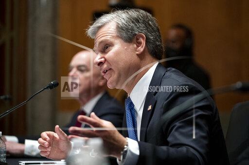 Secretary of Homeland Security Alejandro Mayorkas, left, and FBI Director Christopher Wray, testify before a Senate Homeland Security and Governmental Affairs Committee hearing to discuss security threats 20 years after the 9/11 terrorist attacks, Tuesday, Sept. 21, 2021 on Capitol Hill in Washington. (Greg Nash/Pool via AP)