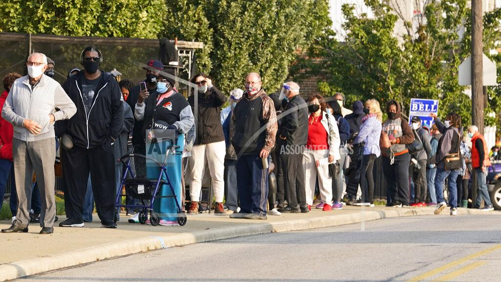 Tony Dejak FILE— In this Oct. 6, 2020 file photo, long lines of people wait outside of the Cuyahoga County Board of Elections to participate in early voting, in Cleveland. (AP Photo/Tony Dejak, File)