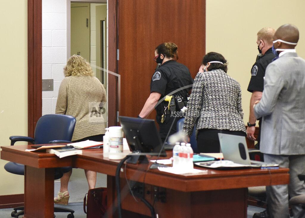 Former MSU gymnastics coach Kathie Klages, left, is led into custody Tuesday, Aug. 4, 2020, after being sentenced in Judge Joyce Draganchuk's courtroom in Lansing, Mich. Klages was found guilty of both charges of lying to police related to an interview about her knowledge of Larry Nassar's abuse in 1997. Draganchuk sentenced her to 90 days in jail with credit for one day served. (Matthew Dae Smith/Lansing State Journal via AP)