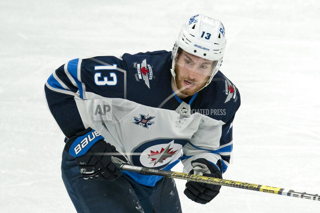 Peter Power FILE - In this March 9, 2021, file photo, Winnipeg Jets center Pierre-Luc Dubois (13) skates during an NHL hockey game against the Toronto Maple Leafs in Toronto. Dubois is looking forward to finally getting to know his Jets teammates after spending much of last season in Winnipeg isolated from them due to COVID-19 protocols coupled with a rash of injuries. (AP Photo/Peter Power, File)