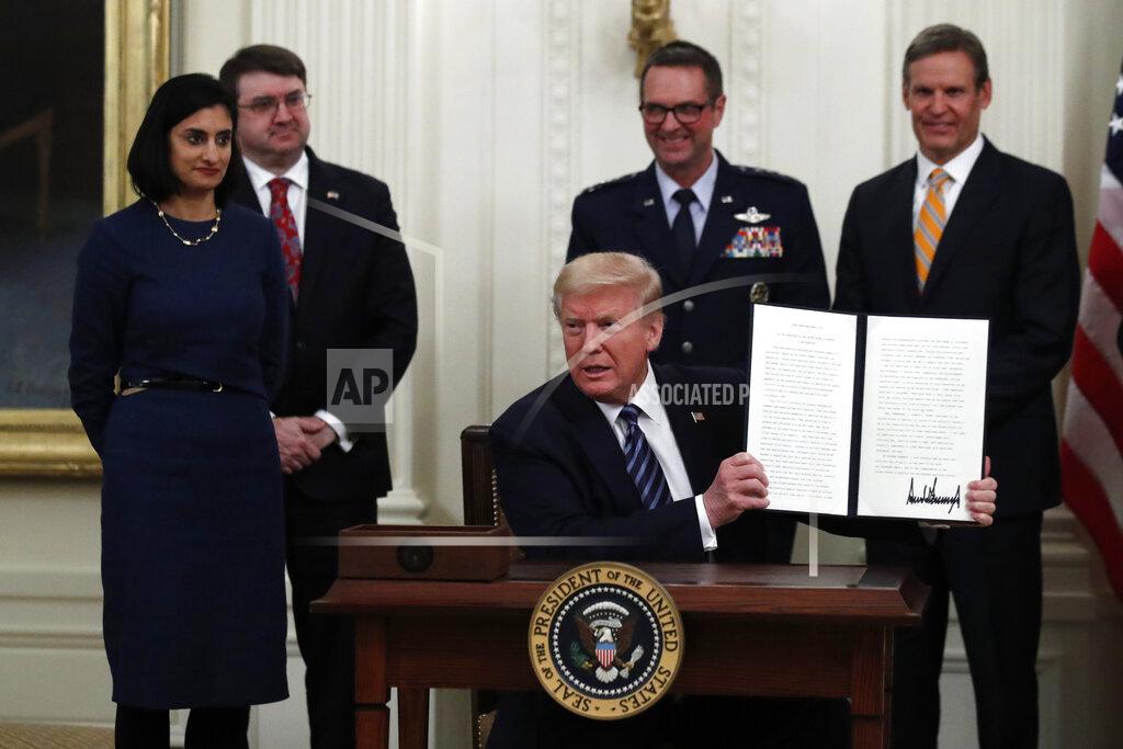 Alex Brandon President Donald Trump holds the signed proclamation for Older Americans Month during an event about protecting seniors, in the East Room of the White House, Thursday, April 30, 2020, in Washington, as from left, Administrator of the Centers for Medicare and Medicaid Services Seema Verma, Veterans Affairs Secretary Robert Wilkie, Gen. Joseph Lengyel, Chief of the National Guard Bureau, and Tennessee Gov. Bill Lee watch. (AP Photo/Alex Brandon)