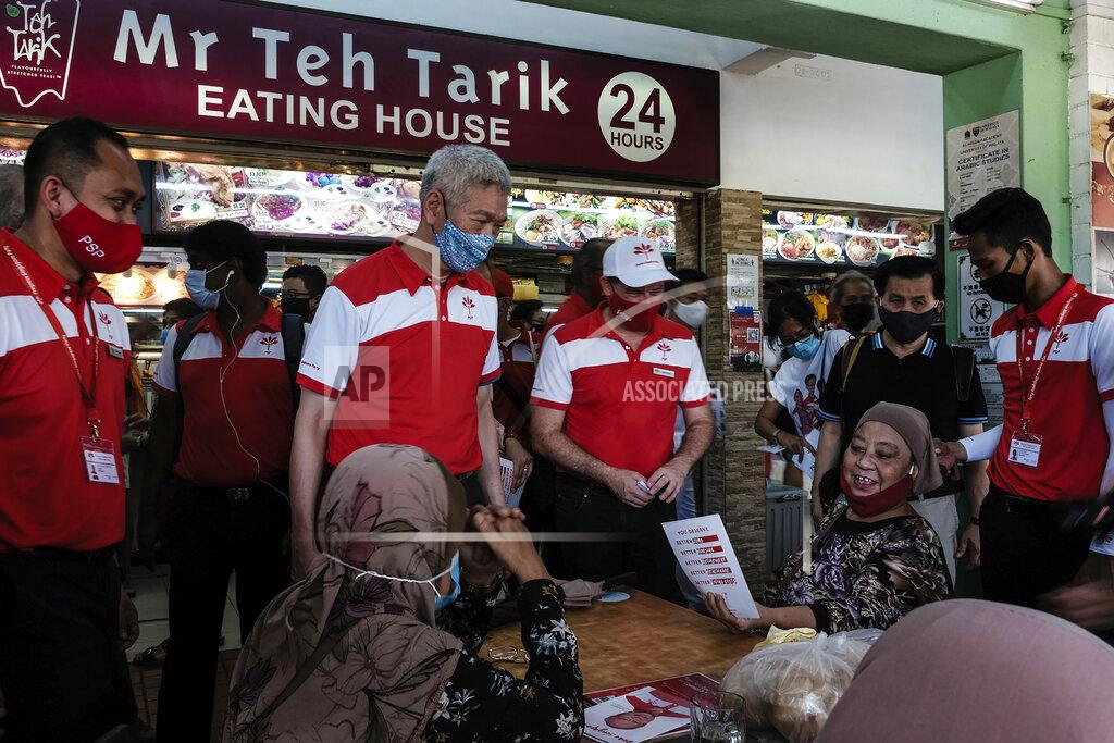 Ee Ming Toh Lee Hsien Yang, center left, the estranged brother of Singapore Prime Minister Lee Hsien Loong, wears a face mask while talking to people at the Chong Pang area during a campaign walkabout for the opposition Progress Singapore Party in Singapore on July 5, 2020. Singaporeans go to the polls on July 10 in Southeast Asia's first election since the coronavirus pandemic began, with the health crisis and an economic recession expected to bolster Prime Minister Lee's party and extend its unbroken rule. (AP Photo/Ee Ming Toh)
