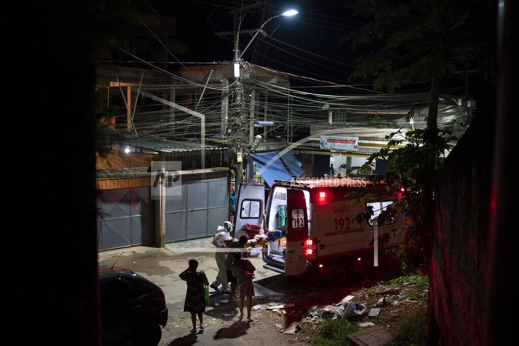 Felipe Dana FILE - In this April 7, 2021 file photo, Mobile Emergency Care Service (SAMU) workers carry an elderly COVID-19 patient to an ambulance in Duque de Caxias, Rio de Janeiro state, Brazil. As Brazil hurtles toward an official COVID-19 death toll of 500,000, its Senate is publicly investigating how the pandemic death toll got so high, focusing on why the government ignored opportunities to buy vaccines while pushing hydroxychloroquine. (AP Photo/Felipe Dana, File)