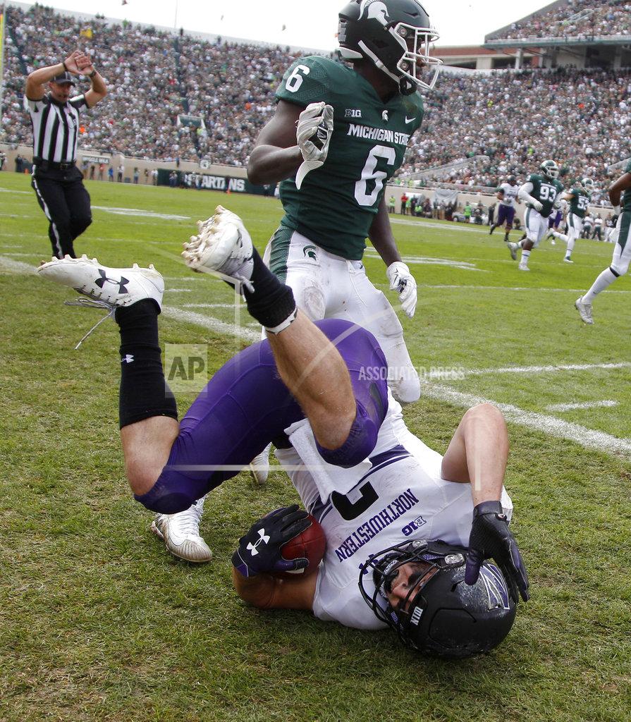 Al Goldis Northwestern's Flynn Nagel, bottom, tumbles after being forced out of bounds by Michigan State's David Dowell (6) in the third quarter of an NCAA college football game, Saturday, Oct. 6, 2018, in East Lansing, Mich. Northwestern won 29-19. (AP Photo/Al Goldis)