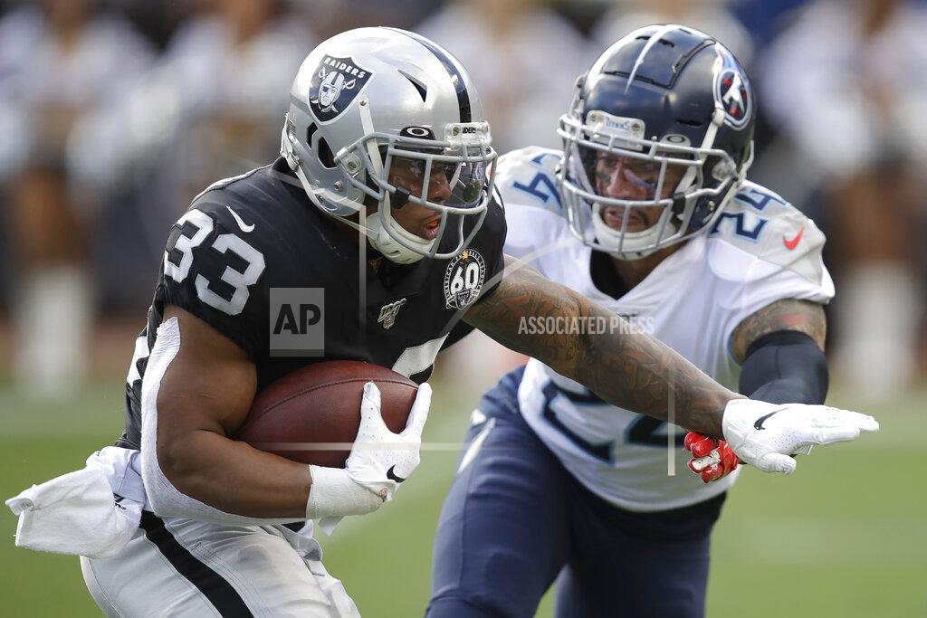 Ben Margot Oakland Raiders running back DeAndre Washington (33) runs for a touchdown past Tennessee Titans strong safety Kenny Vaccaro (24) during the first half of an NFL football game in Oakland, Calif., Sunday, Dec. 8, 2019. (AP Photo/Ben Margot)