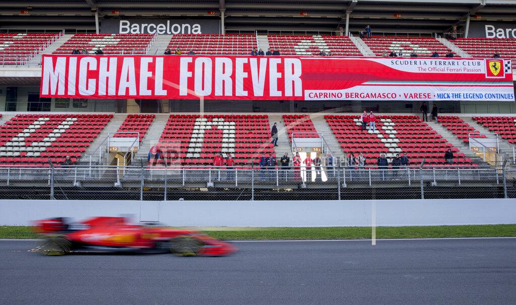 Joan Monfort Ferrari driver Charles Leclerc of Monaco drives past a banner in support of former Ferrari driver Michael Schumacher during a Formula One pre-season testing session at the Barcelona Catalunya racetrack in Montmelo, outside Barcelona, Spain, Thursday, Feb. 28, 2019. (AP Photo/Joan Monfort)