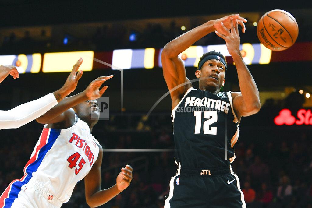 John Amis Atlanta Hawks guard Treveon Graham (12) loses control of a rebouind as Detroit Pistons forward Sekou Doumbouya defends during the first half of an NBA basketball game Saturday, Jan. 18, 2020, in Atlanta. (AP Photo/John Amis)
