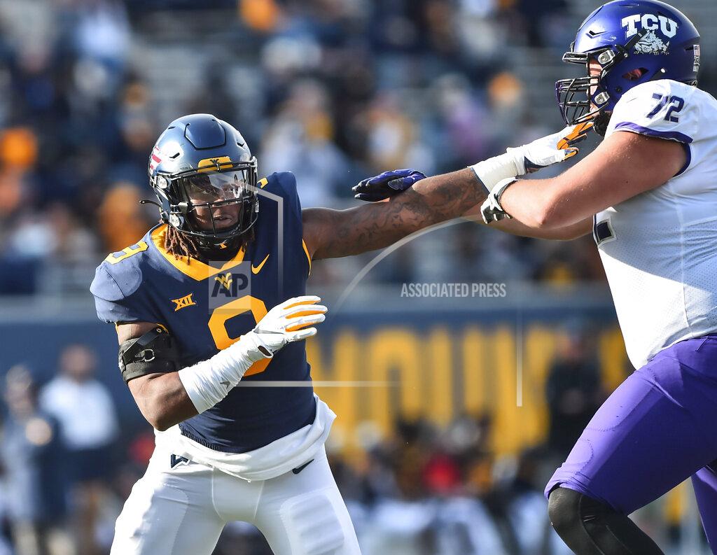 William Wotring West Virginia defensive lineman Jeffery Pooler Jr. (9) works around TCU offensive tackle T.J. Storment (72) during the second half of an NCAA college football game on Saturday, Nov. 14, 2020, in Morgantown, W.Va. (William Wotring/The Dominion-Post via AP)