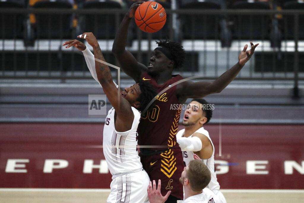 Shafkat Anowar Loyola Chicago forward Aher Uguak, top, reaches for a loose ball as Southern Illinois' Lance Jones, left, tries to block during the second half of an NCAA college basketball game Saturday, Feb. 27, 2021, in Chicago. (AP Photo/Shafkat Anowar)