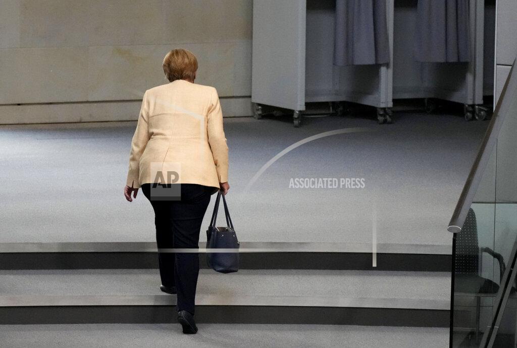 Markus Schreiber File - In this Tuesday, Sept. 7, 2021 file photo, German Chancellor Angela Merkel leaves the plenary hall after a debate about the situation in Germany ahead of the upcoming national election in Berlin, Germany. Angela Merkel, Germany's first female chancellor, has been praised by many for her pragmatic leadership in a turbulent world and celebrated by some as a feminist icon but she wouldn't seek reelection in the country's Sept. 26 general election. (AP Photo/Markus Schreiber, File)