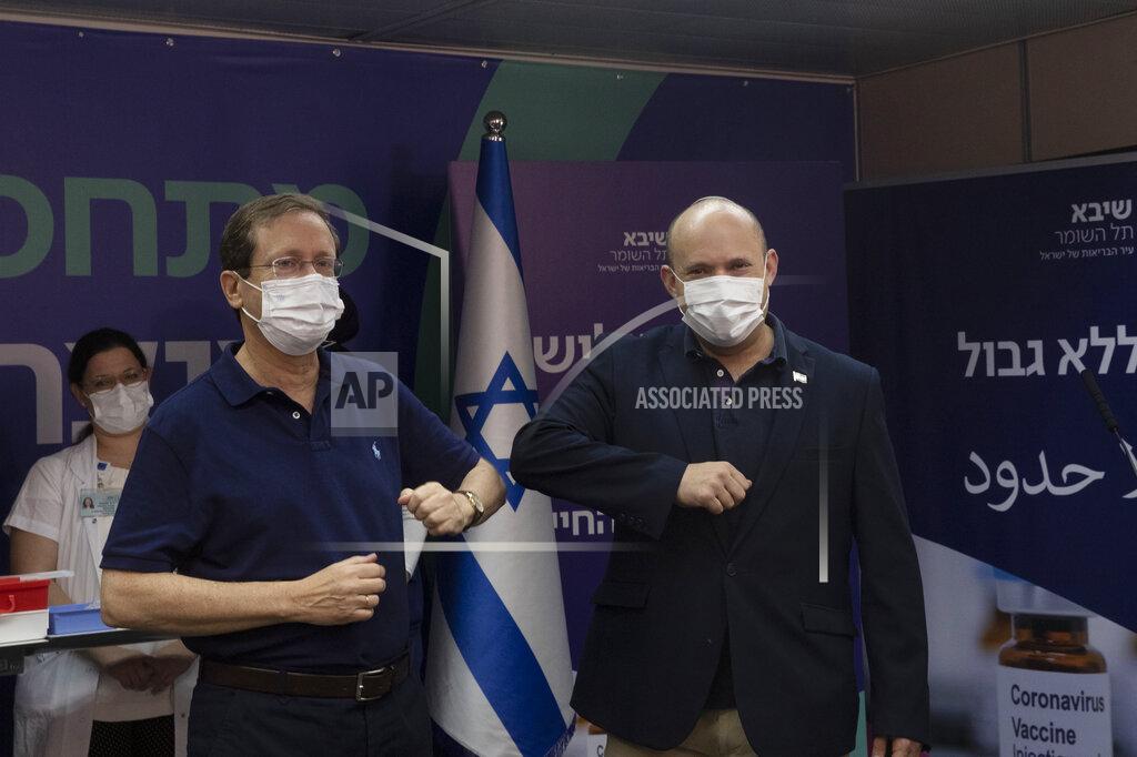 Maya Alleruzzo Israeli President Isaac Herzog left, bumps elbows with Prime Minister Naftali Bennett after he received a third coronavirus vaccine injection at Sheba Medical Center in Ramat Gan, Israel, Friday, July 30, 2021. (AP Photo/Maya Alleruzzo, Pool)