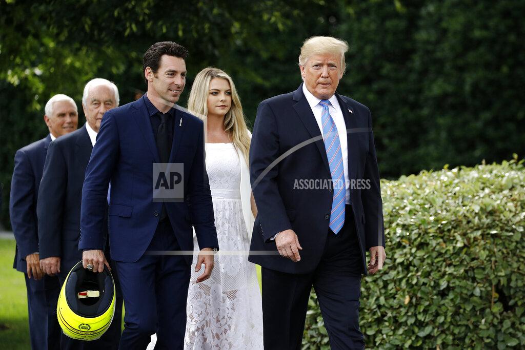 Patrick Semansky President Donald Trump walks with driver Simon Pagenaud to the South Lawn at the White House, Monday, June 10, 2019, in Washington for an event to honor Team Penske for the 2019 Indianapolis 500 win. Walking behind Trump are Vice President Mike Pence, from back left, team owner Roger Penske and Pagenaud's fiancee Hailey McDermott. (AP Photo/Patrick Semansky)