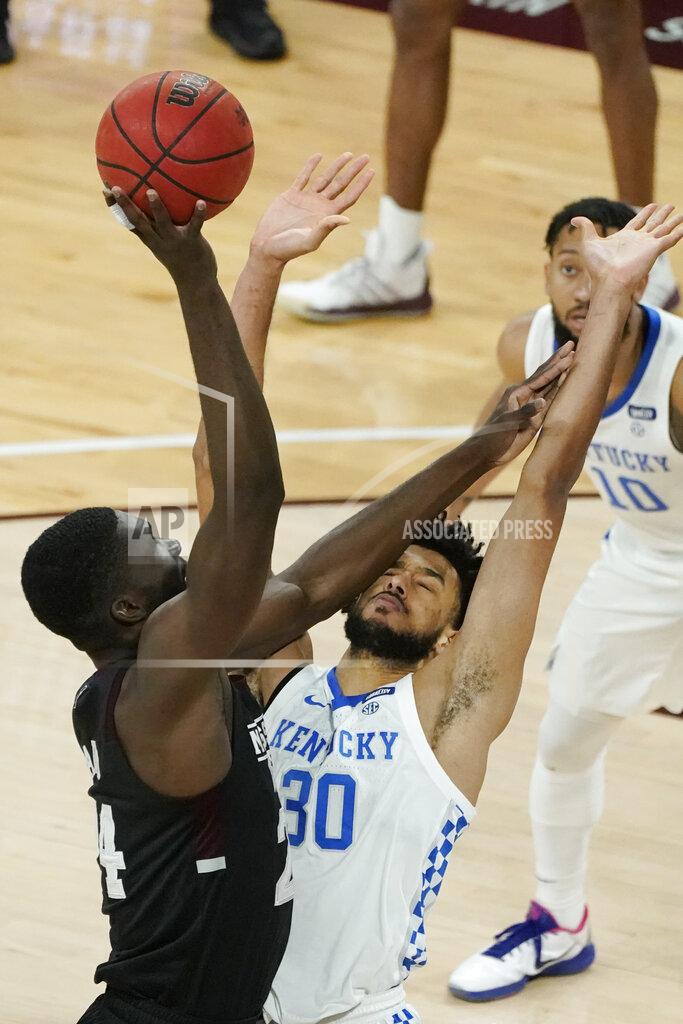 Rogelio V. Solis Mississippi State forward Abdul Ado (24) leans on Kentucky forward Olivier Sarr (30) as he attempts to shoot during the first half of an NCAA college basketball game in Starkville, Miss., Saturday, Jan. 2, 2021. (AP Photo/Rogelio V. Solis)
