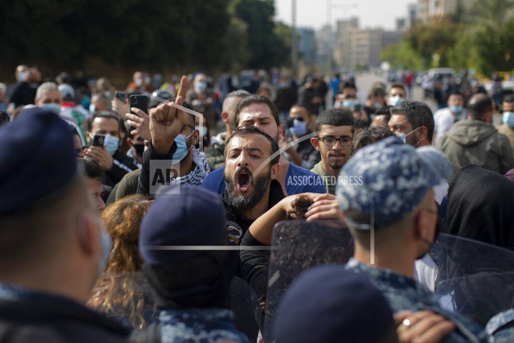 Hassan Ammar An anti-government protester shouts slogans outside a military court, in Beirut, Lebanon, Monday, Feb. 8, 2021. Riot police briefly clashed Monday in Beirut with hundreds of protesters demanding the release of anti-government activists detained following riots in northern Lebanon late last month. (AP Photo/Hassan Ammar)